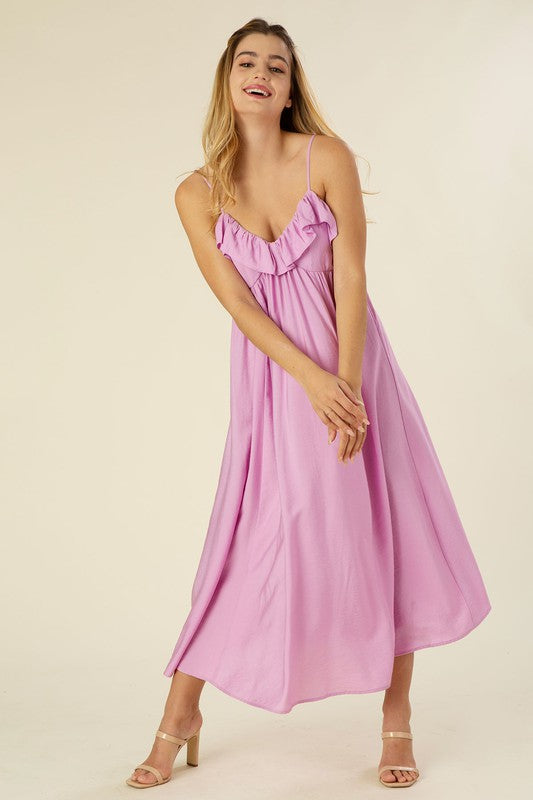 You’ve got us under your spell. Lilac Regal Bohemian Ruffle Maxi Dress is a full skirted maxi dress complete with adjustable spaghetti straps. It’s the vacation ready frock that will transition easily from your bikini coverup to your happy hour outfit. Complete the look with barely there heels, a sleek low bun, and hoops.
