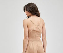Load image into Gallery viewer, Our Above Status Satin Jumpsuit perfect blend of sophistication and texture that adds a touch of elegance to your wardrobe. This satin jumpsuit features a cowl neck design with intricate trim detailing, meticulously woven to create a unique and visually captivating ensemble.
