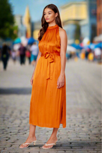 Load image into Gallery viewer, This Summer Lucy Paris dress is made with love for nice sunny days! This is a statement making dress, it has a soft satin feel fabric. Our Lucy Paris sleeveless dress featuring a round neck button collar, with an open back sexy detail, the belt gives it a cute feminine look. You will be sure to turn heads throughout your day at any event. Pair with heels, and your gold accessories.
