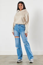 Load image into Gallery viewer, Our New Favorite Vibrant M.i.U high-rise wide fit denim jeans you&#39;ll feel comfortable in them all day long these jeans featuring a classic 5-pocket construction, front cut details, tinted wash throughout, with a zip-fly closure. These jeans are a must-have for your wardrobe this season. Pair with one of our essential bodysuits, pumps, and a jacket for effortless style. 
