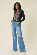 Load image into Gallery viewer, Our New Favorite Vibrant M.i.U Distressed Wide Fit Jeans featuring classic 5-pocket construction, front knee cut details, raw-edged hem, tinted wash throughout, and a zip-fly closure. These jeans are a must-have for your wardrobe this season. Pair with one of our essential bodysuits, pumps, or sneakers and a jacket for effortless style. 
