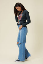 Load image into Gallery viewer, Our New Favorite Vibrant M.i.U Distressed Wide Fit Jeans featuring classic 5-pocket construction, front knee cut details, raw-edged hem, tinted wash throughout, and a zip-fly closure. These jeans are a must-have for your wardrobe this season. Pair with one of our essential bodysuits, pumps, or sneakers and a jacket for effortless style. 
