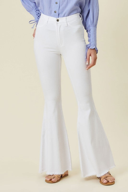 Make a fashion statement in our Vibrant M.i.U High Waisted Flare White Jeans. This jean comes in an extreme flare fit featuring two back patch pockets, faux front pockets, light frayed bottom hem, and a zip-fly closure. Style these jeans with a statement top and a high heel for a look that will have everyone talking.