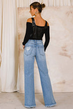 Load image into Gallery viewer, With a high waist and a light wash, these Something New High Rise Distressed Hem Wide Leg Jeans are ideal for dressing up or down. The subtle distressing at the raw hem makes them perfect for taking your style from day to night, while the flared cuffs give a bold look that you won&#39;t want to take off.
