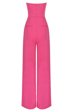 Load image into Gallery viewer, No matter the occasion, the All Inclusive Strapless Jumpsuit is sure to impress!  Featuring a hugging figure with an invisible zip closure at back, princess-seamed bodice with an elasticized back, strapless and welt pockets detailing. This endless strapless pink jumpsuit in classic solid color is perfect from day to night. Complete it with a mini clutch and heels for a sophisticated look. 

