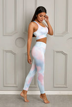 Load image into Gallery viewer, Stand out from the crowd with a bright pop of color to inspire your new moves. Work out in style with this eye-catching tie-dye print workout set that comes with a racerback sports bra and high-rise leggings. This style looks great back with the matching tight and an cut out back top to show off the back strap detail. Moisture wicking and breathable, you&#39;ll feel cool, comfortable and stylish. This set is perfect if you want to look stylish while working out in gym or studio.
