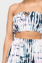 Load image into Gallery viewer, Keep it totally trendy in tie dye and get in touch with your playful side! This multi color crop top features a strapless neckline and a elastic band hem. The vibrant blues, pink, and lilac and compose a fun tie dye pattern. Pair this set with a simple high heels, silver accessories and mini bag for a complete look. 
