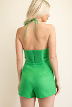 Load image into Gallery viewer, Be sure to stand out in sweeter than ever kelly green romper wherever you go from day to night in style! Featuring shapes, a strapless neckline, halter necktie, elastic at the back and a cut out front, textured woven fabric and princess bow. Totally on-trend, tie-front detail accents this chic romper perfectly while pleated shorts complete the look! Hidden back zipper/clasp. 
