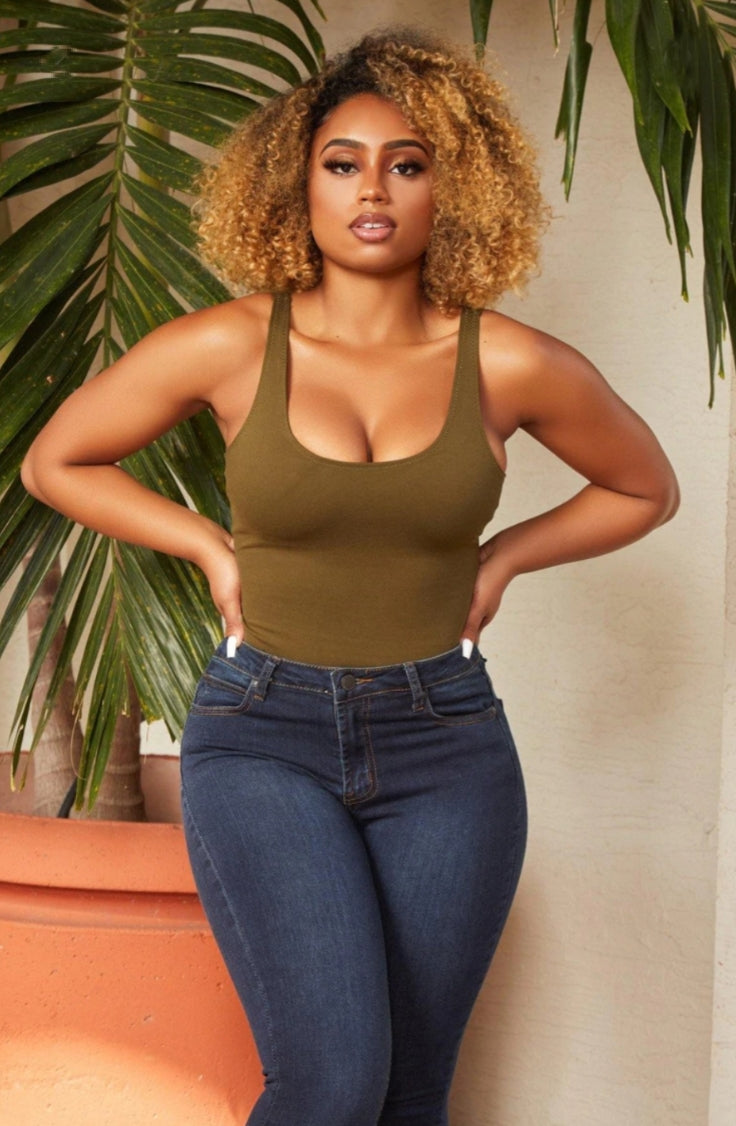 Our basic bodysuits are essential and endlessly versatile for all seasons! Featuring a scoop neckline, stretchy material, and snap button closure; this bodysuit contours your body. Style with a high-rise denim jean and transparent heels for an effortlessly fab look we adore. 