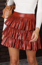 Load image into Gallery viewer, Our enticed by your lust leather mini skirt is sure to give your look a fiercely feminine finish. Featuring a faux leather material, a pleated three-layer ruffle hem and elasticated waistband, team it with a bodysuit or fitted top and heels for a look we&#39;re loving.
