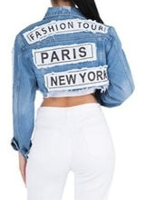 Load image into Gallery viewer, Update your denim collection with our cropped jacket we are obsessing over. Featuring a mid wash denim material with a raw edge and a cropped length, double up your denim with our matching mid-wash jeans and a nude crop top for a combo that can be dressed up or down.
