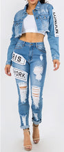 Load image into Gallery viewer, We are obsessing over these distressed mid rise jeans. Featuring a trendy medium wash denim, distressed and, patchwork features. Make these jeans your go-to to when putting together the perfect outfit. Pair these jeans with a statement top and our favorite transparent heels for a look we&#39;re loving.
