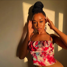 Load image into Gallery viewer, This satin tie die festival top is sure to take your weekend look that extra mile. Featuring a pink, white and baby blue material with a backless design and thin strap detailing, cowl neckline and a cropped length. Style with blue jeans and high heels for a date night with the bae.
