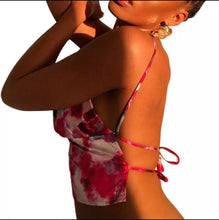 Load image into Gallery viewer, This satin tie die festival top is sure to take your weekend look that extra mile. Featuring a pink, white and baby blue material with a backless design and thin strap detailing, cowl neckline and a cropped length. Style with blue jeans and high heels for a date night with the bae.
