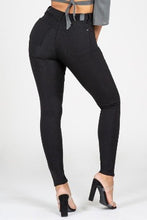 Load image into Gallery viewer, If you don&#39;t have this closet essential, you are missing out! These high rise, black, skinny jeans are made of super stretchy material and making them the jeans that every girl needs. They feature two back pockets and a front zipper and button to close. These are the pants that you can wear to work, dinner, or the club. Pair with heels and a great top to create the perfect outfit.
