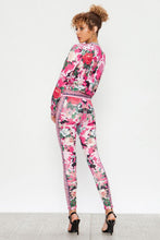 Load image into Gallery viewer, We&#39;re bringing you the ultimate Flowers and Camo tracksuit! Perfect for building your favorite looks all year round. This tracksuit is luxurious, has excellent stretch, and extremely comfortable. The jacket is long sleeve, soft stretch fit, with a front zipper. The bottoms are stretchy waistband and hugs you in all the right places. Pair with transparent heels, gold jewelry to create a cute and casual look. 
