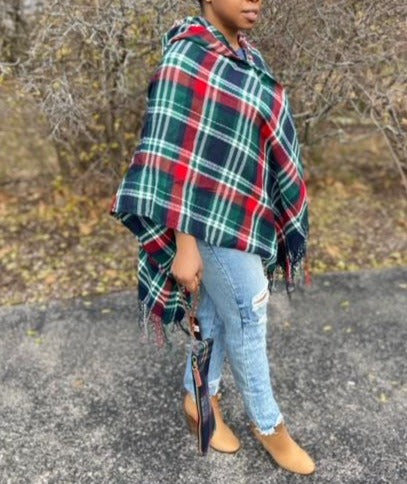 Drape yourself in style and warmth with our pretty Giving You Everything poncho featuring warm material plaid patterned with a roomy hood, open sides, and an ultra-draped silhouette that falls into an uneven knee-length hemline with fringe trim detailing!