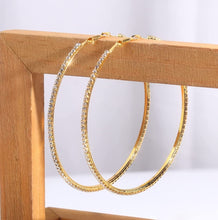 Load image into Gallery viewer, Add some sparkle and shine with these beautifully detailed gold hoop earrings. Featuring jeweled detailing on a gold-tone setting, these earrings are perfect for all occasions.
