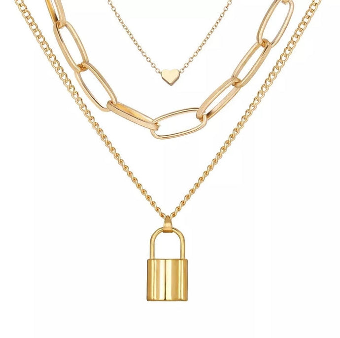 Golden Heart Lock Locket Necklace - Gold Make a bold accessory statement with this golden locket chain necklace. Featuring three chains golden lock locket; we're simply in love! Featuring thin chains detail and clasp closure. Dress it up or down, our jewelry collection is filled with pieces that add instant polish.