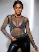 Load image into Gallery viewer, Can you feel the love tonight in this season with this flirty  top is made from a rhinestone netting fabrication, long sleeve and is complete with a crew neckline. This top will make any outfit special. Style this mesh rhinestone crop over your favorite bralette top and a pair of high waisted leather pants for a sexy glam date night look!
