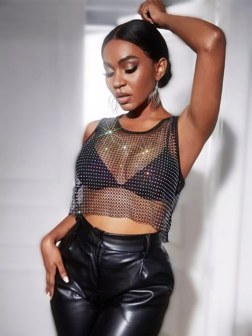  Can you feel the love tonight in this season with this flirty crop top is made from a rhinestone netting fabrication, sleeveless and is complete with a crew neckline. This top will make any outfit special. Style this mesh rhinestone crop over your favorite bralette top and a pair of high waisted leather pants for a sexy glam date night look!