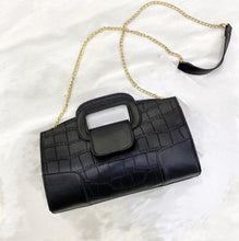 Load image into Gallery viewer, Finish off your evening look with this classy handbag babe. Featuring a black faux leather material, and this bag comes with a crossbody strap, a gold link strap for the shoulder, front flap design and a metal popper fastening. Style with any of your night time looks!
