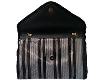 Load image into Gallery viewer, After looking high and low, traveling far and wide, our journey finally brought us to Night Life Sequin Clutch! This cute black clutch features rows of stunning black and silver sequin, and black fringe. Lift the top from the hidden magnetic closure to find a striped, lined interior with a sidewall pocket. Detachable chain strap.
