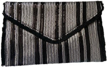 Load image into Gallery viewer, After looking high and low, traveling far and wide, our journey finally brought us to Night Life Sequin Clutch! This cute black clutch features rows of stunning black and silver sequin, and black fringe. Lift the top from the hidden magnetic closure to find a striped, lined interior with a sidewall pocket. Detachable chain strap.
