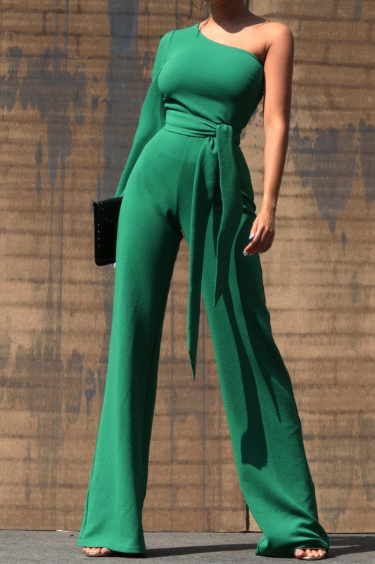 One Shoulder Jumpsuit - Dark Green This jumpsuit is a statement in itself! Perfect for all of your summer fun! This green jumpsuit comes in a wide pant leg featuring a long sleeve one shoulder, adjustable tie belt, and side zipper. Pair this with a stylish heel and handbag for a complete look.