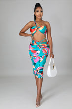 Load image into Gallery viewer, This sexy Picasso skirt set is everything and a definite must have for your wardrobe babe. Easy to style and has plenty stretch! This super cute skirt set comes in a mid length featuring a ruched detail, elastic waistband and matching cross wrap top. Pair with a statement high heels and handbag for a complete look. 
