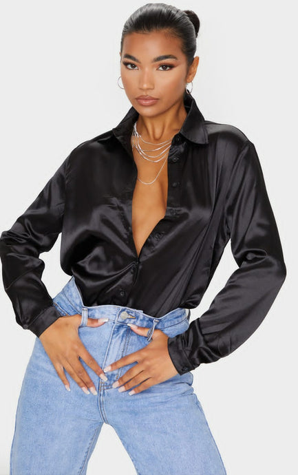A timeless classic blouse made from the finest silk. Featuring a luxe black satin fabric, a loose fit and button up front - this shirt can be styled up or down whatever the occasion. Team it with some high waist pants and strappy heels for a must have look.