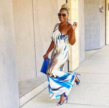 Load image into Gallery viewer, Keep your look like a work of art, in this dreamy maxi dress. Featuring a white, blue and brown material with a one shoulder neckline, we&#39;re in love. Add gold earrings, white high heels, and a matching purse to keep the look effortlessly amazing.
