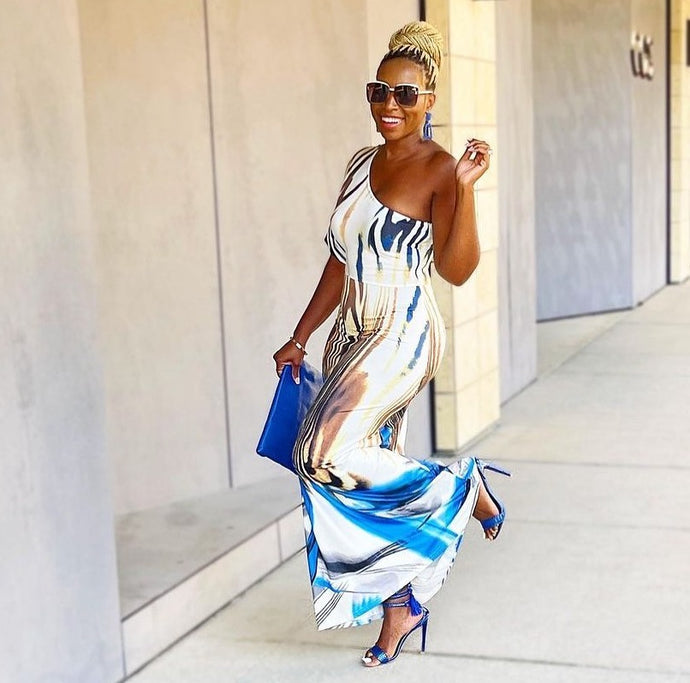 Keep your look like a work of art, in this dreamy maxi dress. Featuring a white, blue and brown material with a one shoulder neckline, we're in love. Add gold earrings, white high heels, and a matching purse to keep the look effortlessly amazing.
