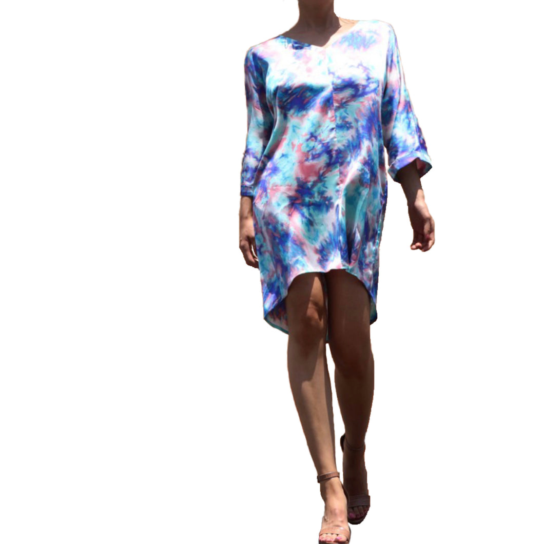 Dipped N' Sunset - Blue Pryceless Angels we're obsessing over this tie dye high low mini print dress! You can wear it from work to a night out, this dress is super versatile for multiple occasions! This loose fitting dress has a soft satin feel featuring two side pockets a multicolored tie dye print, V- Neck, you definitely need this in your new season collection. Pair with a strappy blue, pink or transparent high heels and clutch for a complete look.   