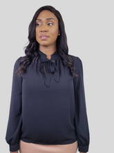 Load image into Gallery viewer, Girl we are lovin&#39; this blouse top, featuring a white soft material, with a tie up riffle collar. Team this with matching satin trousers and killer heels for that last minute night out outfit. 
