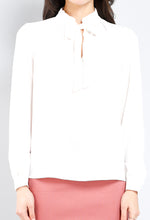 Load image into Gallery viewer, Girl we are lovin&#39; this blouse top, featuring a white soft material, with a tie up riffle collar. Team this with matching satin trousers and killer heels for that last minute night out outfit. 
