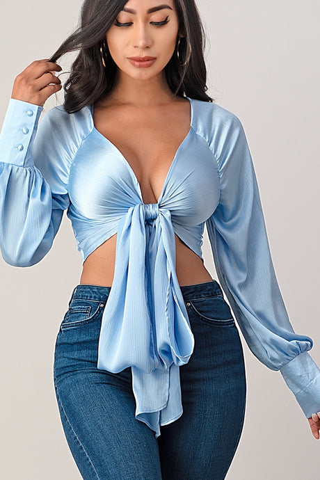 This top and color combination is everything! It has the perfect colors for a transition into this season. This crop top features a classic collar neckline, baby blue satin material, tie front, and plunge neckline. Whether you pair with jeans, leather pants or shorts; this top is definitely a hit! 