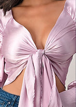 Load image into Gallery viewer, This top and color combination is everything! It has the perfect colors for a transition into this season. This crop top features a classic collar neckline, lilac satin material, tie front, and plunge neckline. Whether you pair with jeans, leather pants or shorts; this top is definitely a hit! 
