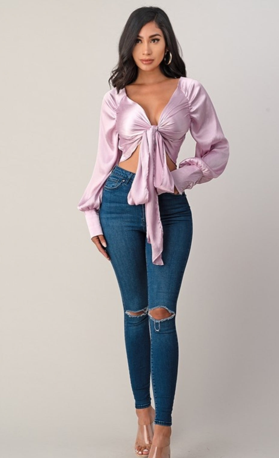 This top and color combination is everything! It has the perfect colors for a transition into this season. This crop top features a classic collar neckline, wisteria satin material, tie front, and plunge neckline. Whether you pair with jeans, leather pants or shorts; this top is definitely a hit! 