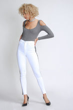Load image into Gallery viewer, Flex your style in these cute white skinny Jeans with a contrast black stripe designs. Perfect for styling any and every way you want! These jeans come in a high rise fit featuring a raw uneven hem ends, zip and button closure. Pair with a graphic tee or chic fashion top, high heels or combat boots and of course a handbag for a complete look!
