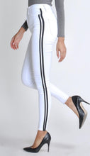 Load image into Gallery viewer, Flex your style in these cute white skinny Jeans with a contrast black stripe designs. Perfect for styling any and every way you want! These jeans come in a high rise fit featuring a raw uneven hem ends, zip and button closure. Pair with a graphic tee or chic fashion top, high heels or combat boots and of course a handbag for a complete look!

