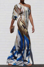 Load image into Gallery viewer, Keep your look like a work of art, in this dreamy maxi dress. Featuring a white, blue and brown material with a one shoulder neckline, we&#39;re in love. Add gold earrings, white high heels, and a matching purse to keep the look effortlessly amazing.
