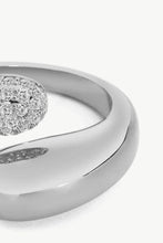 Load image into Gallery viewer, A simplistic yet elegant ring with a geometric style featuring a bypass design fashioned from polished stainless steel and crystals.
