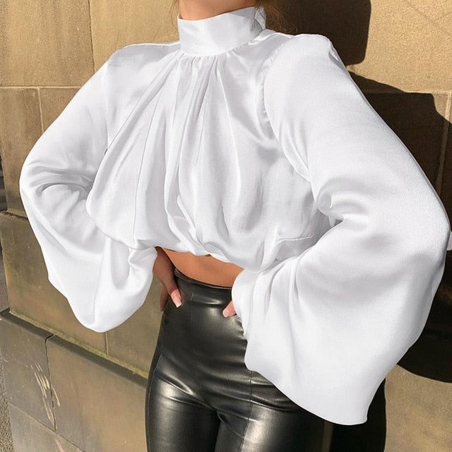 Girl we are lovin' this She's So Classy Blouse crop top, featuring a white satin material, with a turtleneck collar. Team this with matching satin trousers and killer heels for that last minute night out outfit. 