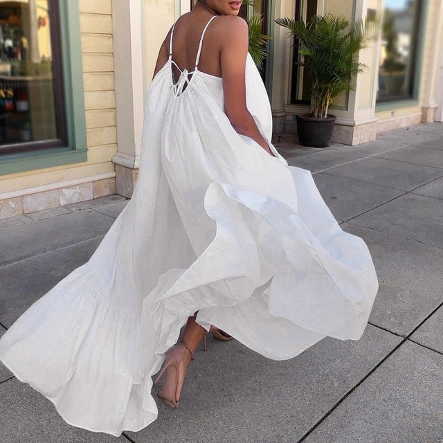 You’ve got us under your spell. So Royal Bohemian Maxi Dress is a full skirted maxi dress complete with adjustable spaghetti straps, a back tie, and a ruffled hem. It’s the vacation ready frock that will transition easily from your bikini coverup to your happy hour outfit. Complete the look with barely there heels, a sleek low bun, and hoops.