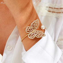 Load image into Gallery viewer, A statement bracelet is a must have in your wardrobe this season or a perfect gift for any occasion. Adjustable and a comfortable fit that works for you. Featuring a classic butterfly design and the silver pearl placed on the end of the open bangle creates a new artistic beauty on you. The rhinestones have a remarkable glisten to it, and when light hits them the effect is truly special. 

