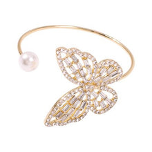 Load image into Gallery viewer, A statement bracelet is a must have in your wardrobe this season or a perfect gift for any occasion. Adjustable and a comfortable fit that works for you. Featuring a classic butterfly design and the silver pearl placed on the end of the open bangle creates a new artistic beauty on you. The rhinestones have a remarkable glisten to it, and when light hits them the effect is truly special. 
