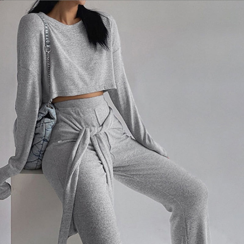 Every fashionista knows she must have this cute & comfy set in her fall fashion wardrobe. Featuring a soft gray knitted crop top, wide leg pants with elastic waistband with belt. Make this set this seasons go-to when dressing them up with your favorite accessories from home!