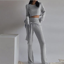 Load image into Gallery viewer, Every fashionista knows she must have this cute &amp; comfy set in her fall fashion wardrobe. Featuring a soft gray knitted crop top, wide leg pants with elastic waistband with belt. Make this set this seasons go-to when dressing them up with your favorite accessories from home!
