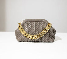Load image into Gallery viewer, Complete your look with this chic faux leather bag featuring a thick gold chain and fully lined interior. Roomy enough to fit all of your day-to-day essentials. Pair with your little black dress for a night out or add some glitz and glam to your denim looks.
